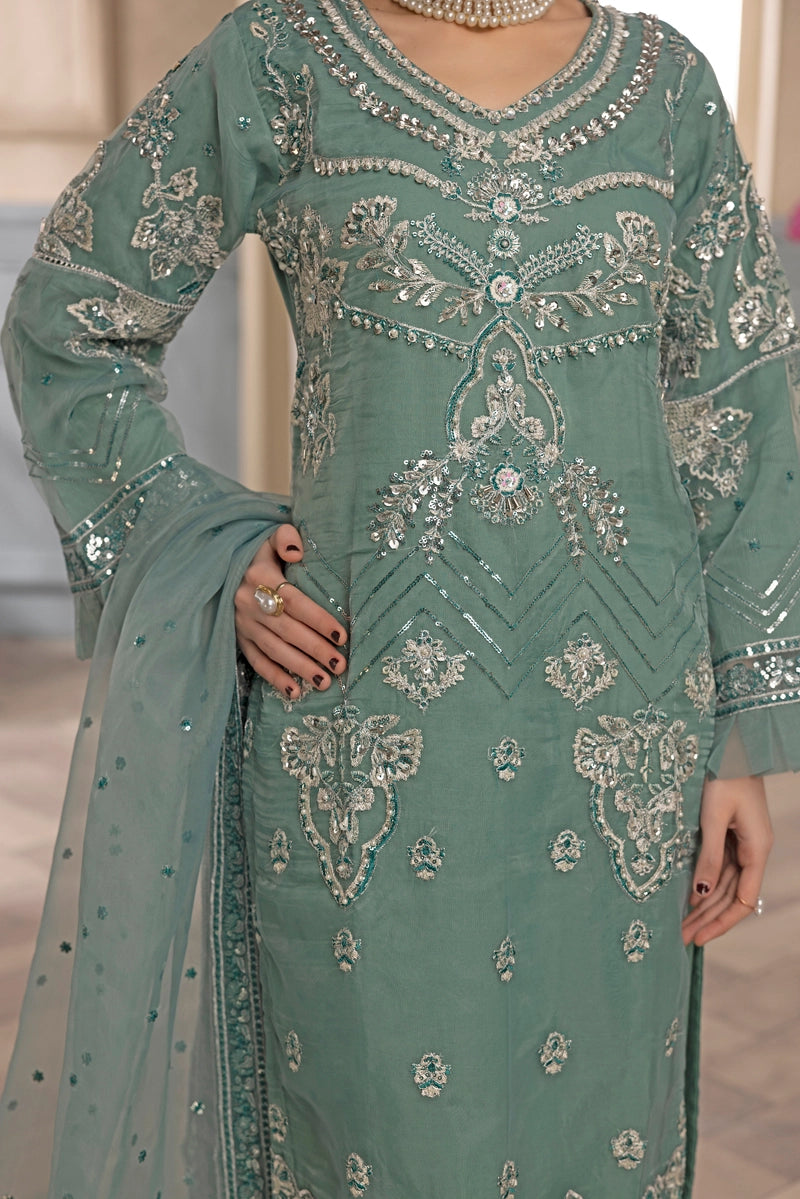 Green embroidered traditional outfit with intricate patterns