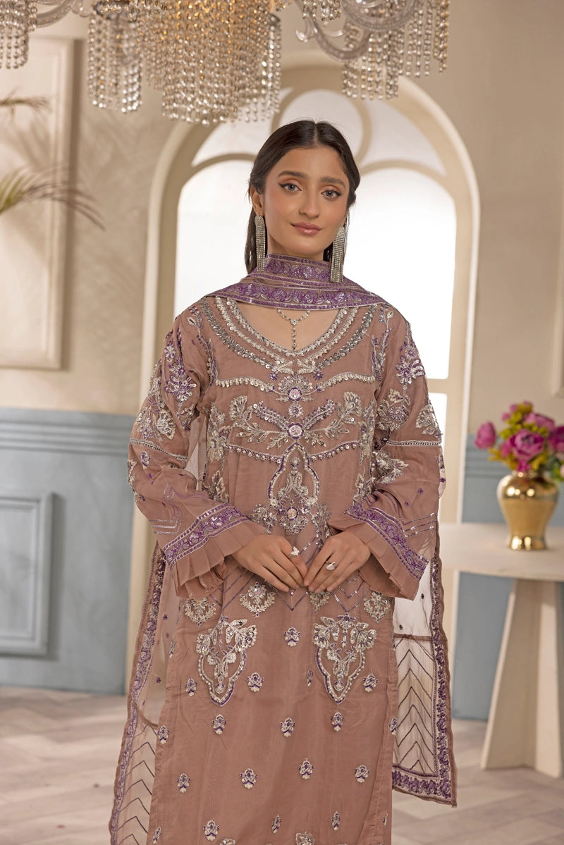 Woman wearing a traditional embroidered outfit in an elegant interior setting