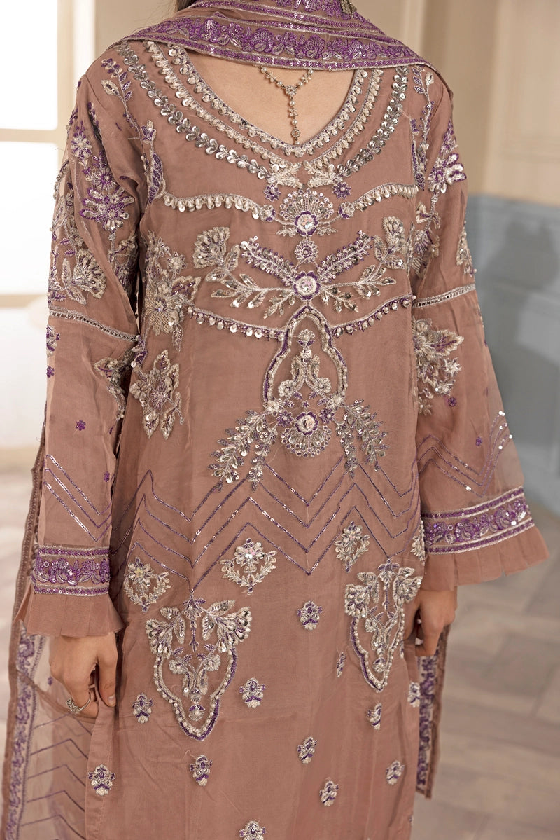 Brown embroidered dress with intricate patterns on a neutral background