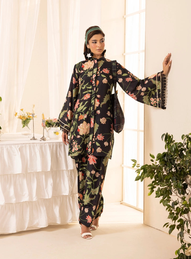 Woman in a floral outfit standing in a bright room with plants and a table.