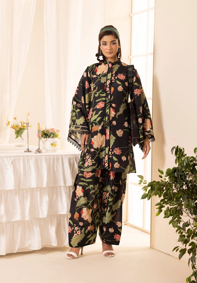 Woman wearing a floral outfit standing in a bright room with white curtains and a table.