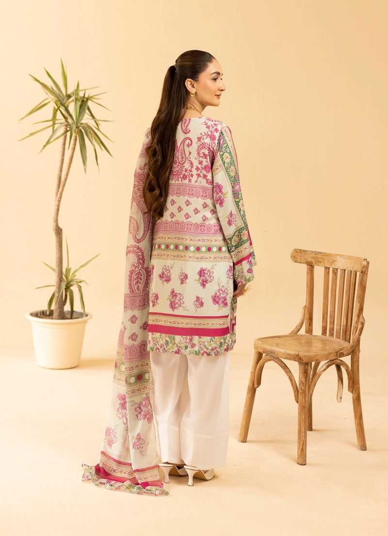 Woman wearing a pink and white embroidered traditional outfit with a wooden chair and plant in the background.