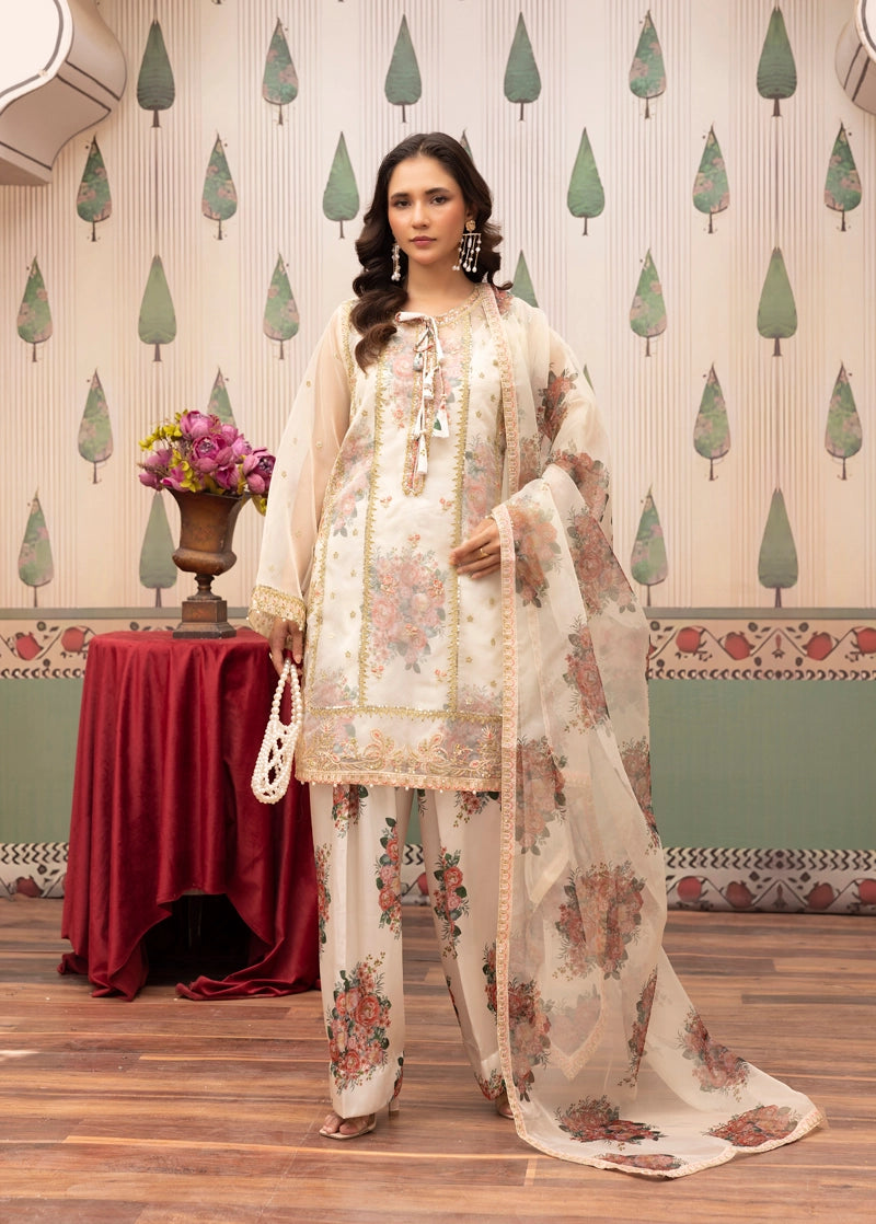 Woman in a floral outfit standing in a decorated room with a table and vase.