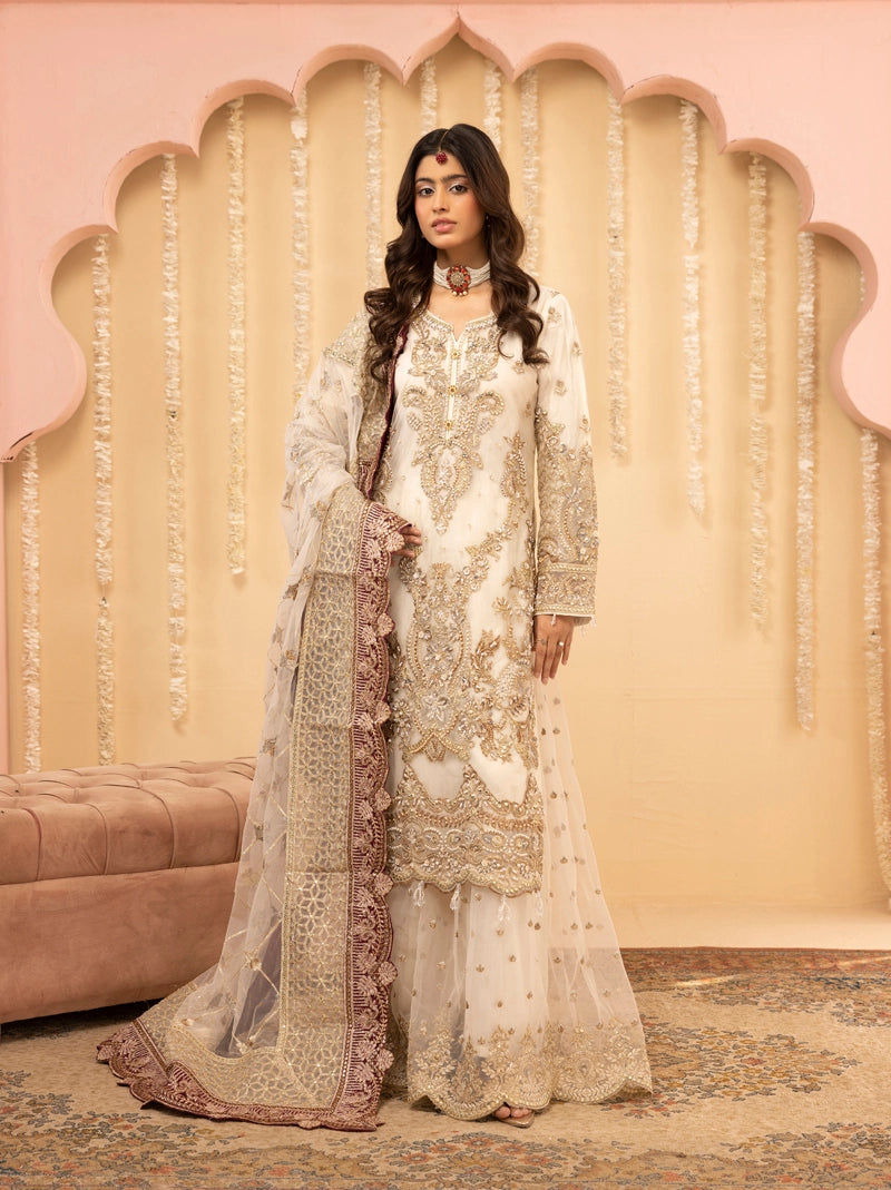 Woman in traditional embroidered outfit with a decorative pink and beige background