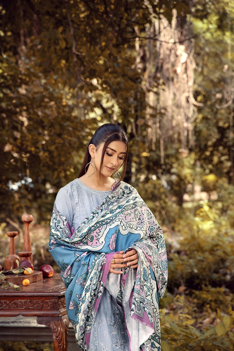 Woman in a floral shawl standing in a forest setting