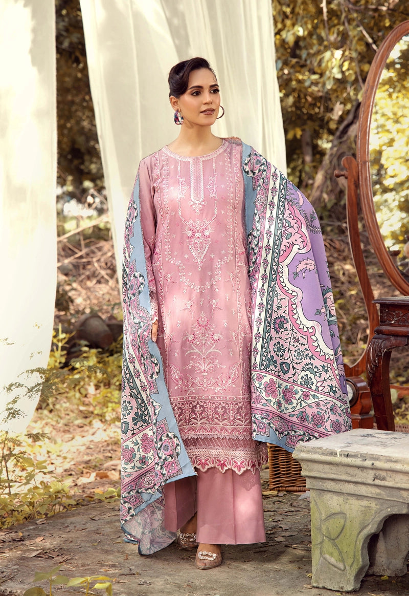 Woman in a pink traditional outfit with a floral shawl outdoors.