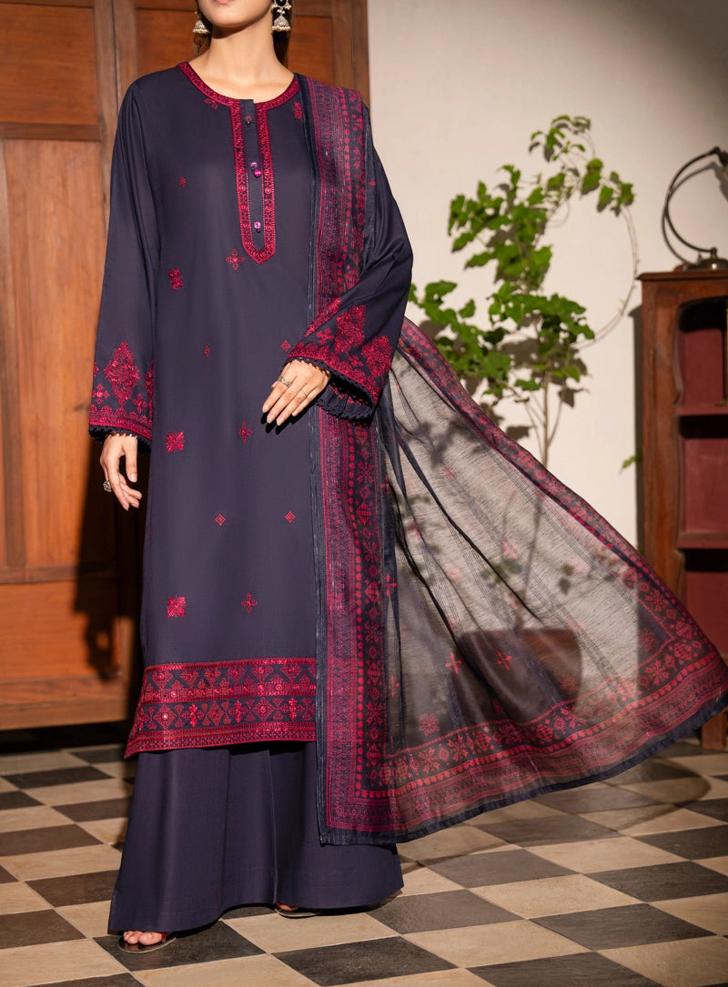 Woman wearing a dark blue traditional outfit with red embroidery on a checkered floor.