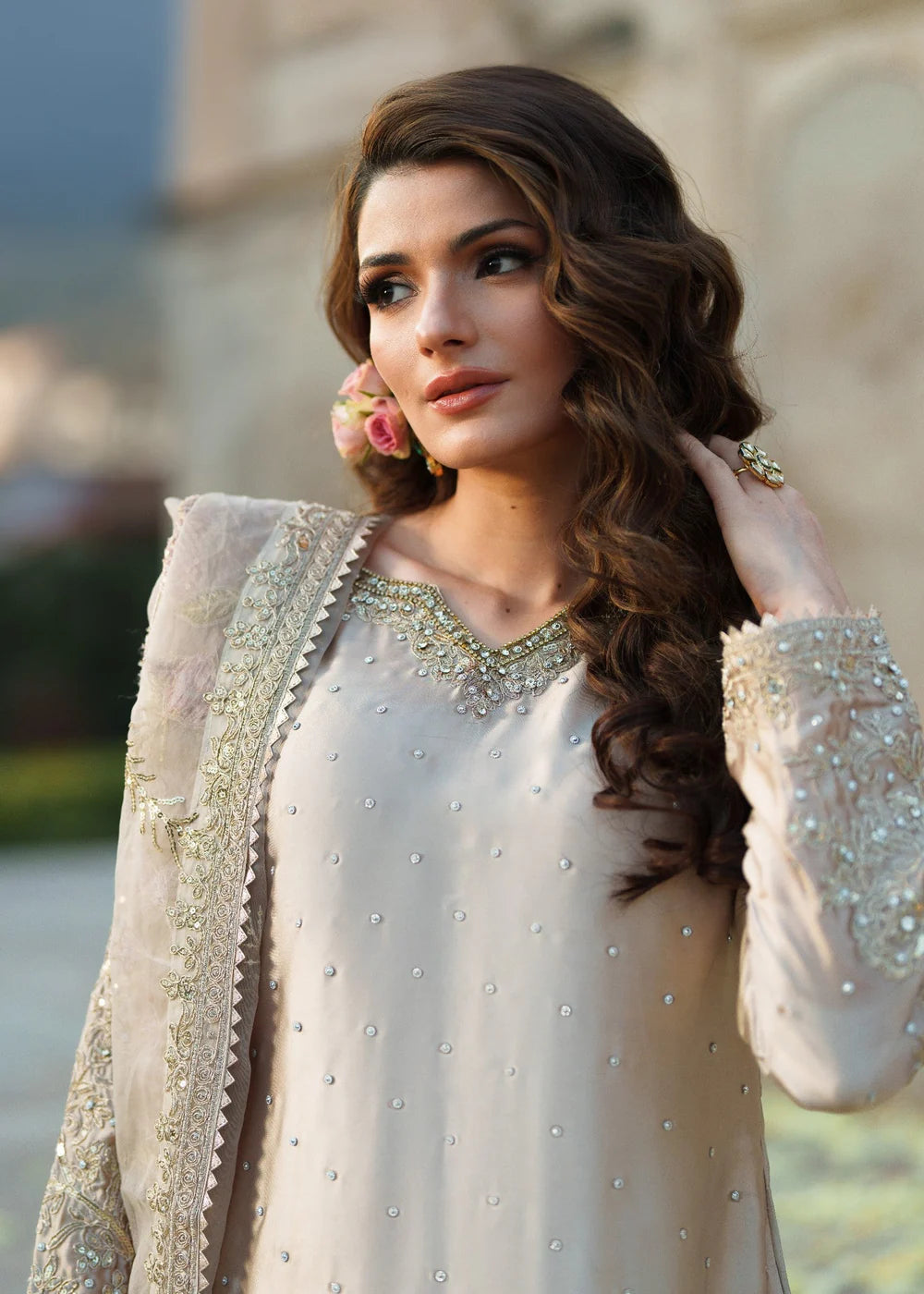 Woman in traditional outfit with embellishments outdoors