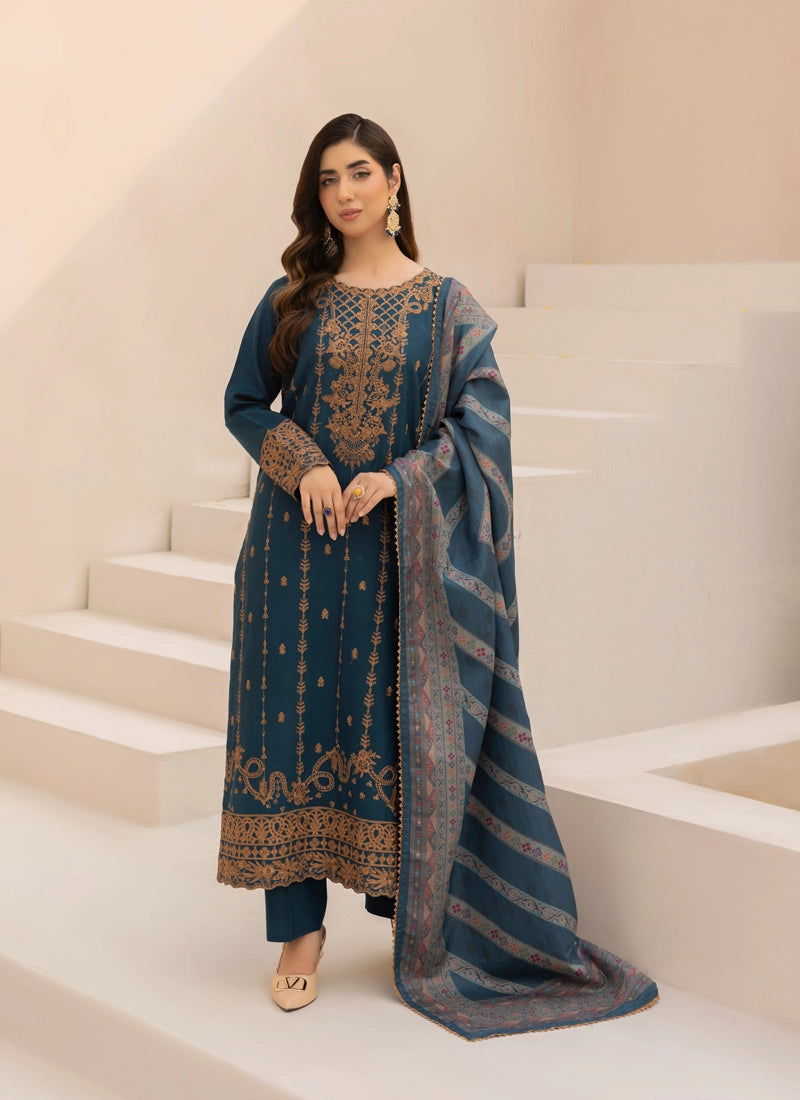 Woman in a blue embroidered outfit standing on a staircase