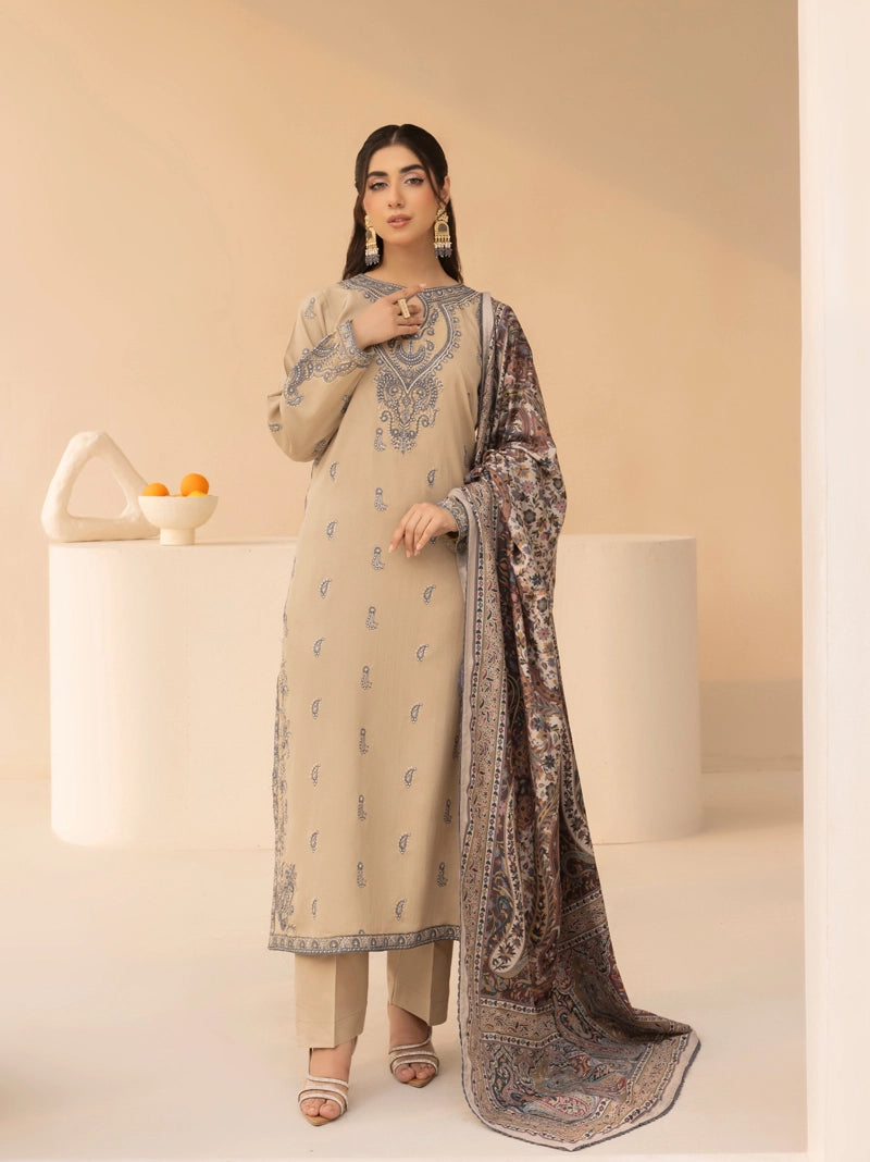 Woman wearing a beige and patterned outfit with a dupatta on a neutral background