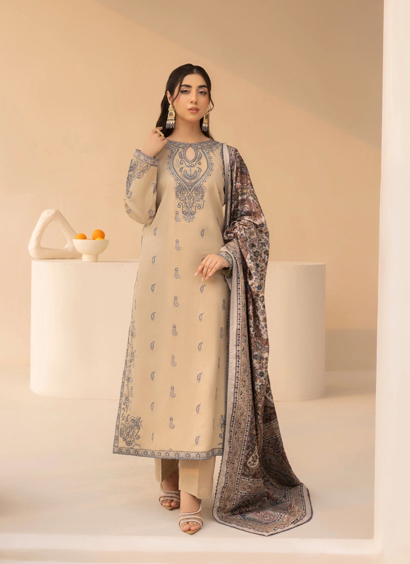 Woman wearing a beige and black embroidered traditional outfit with a matching dupatta on a neutral background.