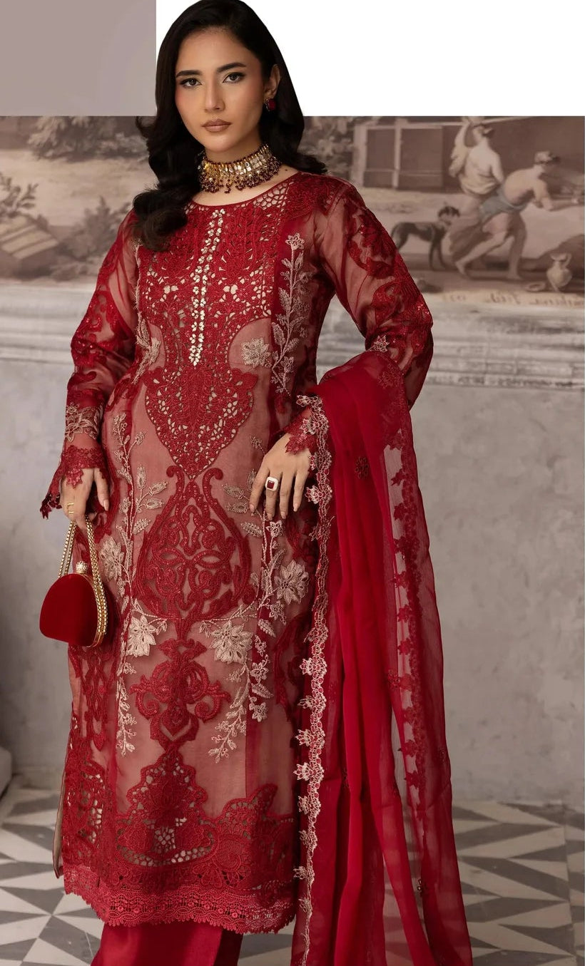 Woman wearing a red embroidered traditional outfit with a matching dupatta against a vintage-style background.